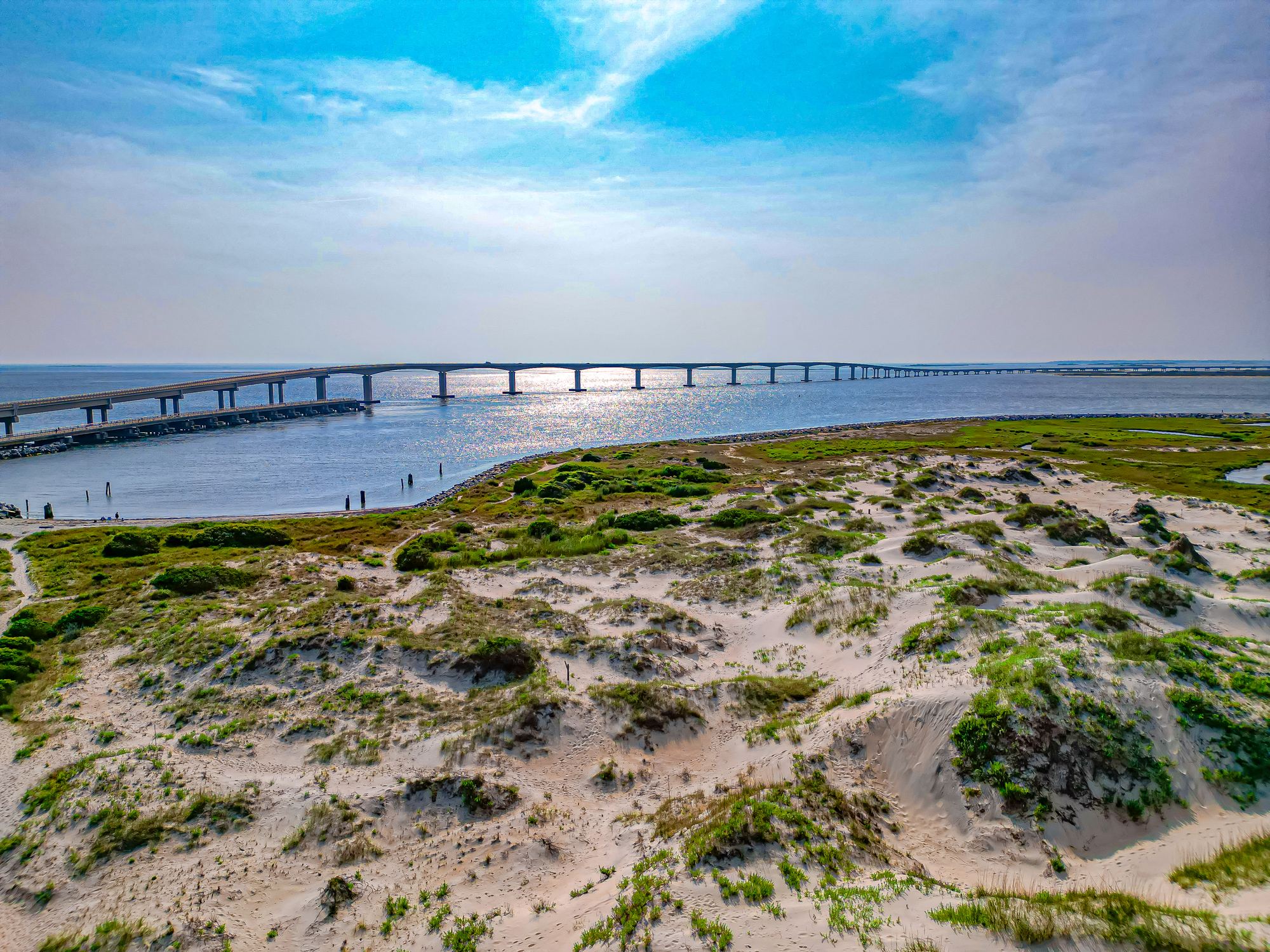 Aerial view of the Marc Basnight Bridge curving over Oregon Inlet
